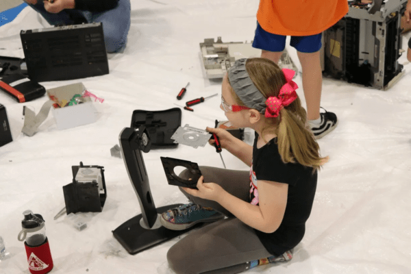 Picture of a young girl assembling a device
